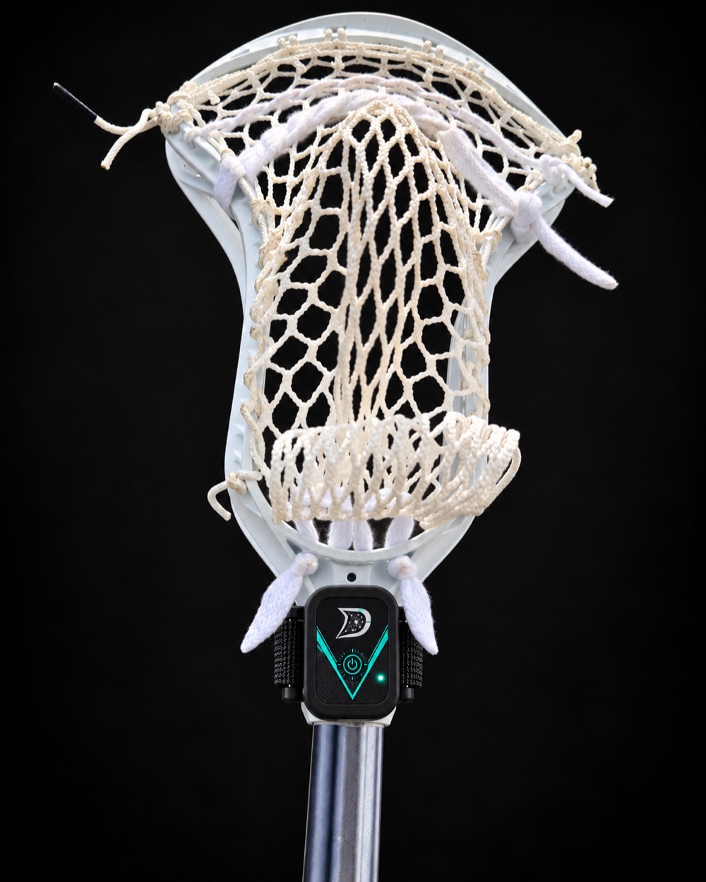 The Dial strapped at the throat of a lacrosse stick